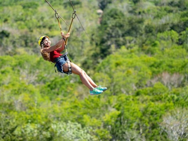 Feel the breeze while zip lining the highest zip line in the Riviera Maya on the Full Day Mayan Coba Ruins and ATV Tour