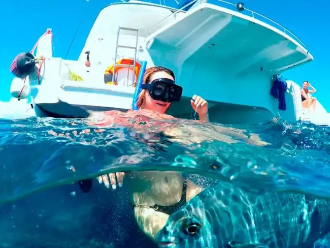 Jump in the crystal clear waters and have an amazing time swimming with a variety of fish around you while sailing on a 45 guest Private Catamaran Full Day to Isla Mujeres