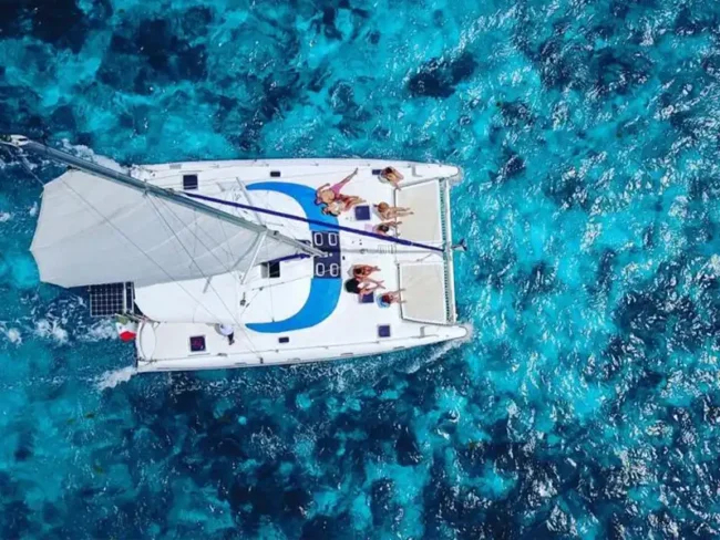 Have a relaxing time under the sun while experiencing this beautiful turquoise blue sea sailing on our Full Day Sail Cat 30 Guests to Isla Mujeres Tour