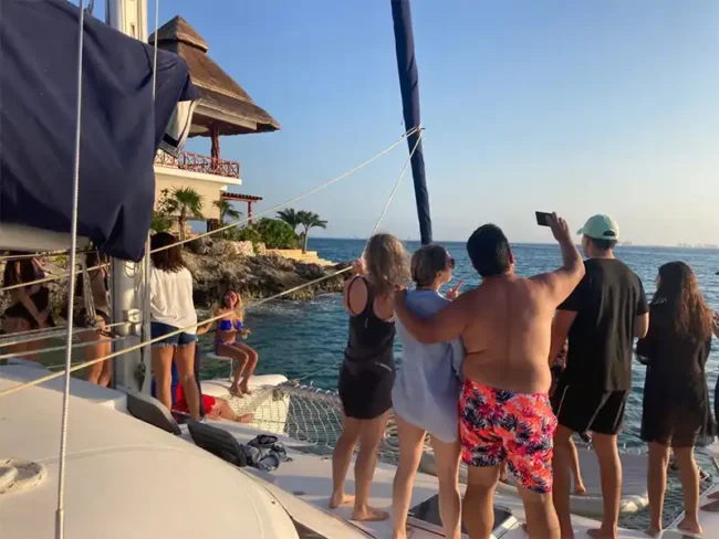 Enjoy the sunset with a tequila party, dance or relax on the Catamaran's net, and create the best moments with your family and friends at the Sail Cat 30 Guests to Isla Mujeres tour