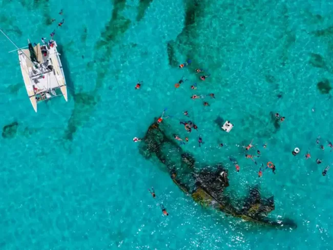 Jump in nice turquoise waters and snorkel around the sunken boat on our half day private catamaran tour to Isla Mujeres