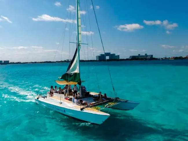 Sail to Isla Mujeres on a half day private catamaran while enjoying the amazing view of the crystal clear sea