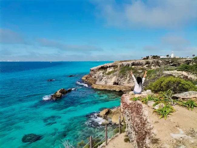 Go on a golf cart and visit south beach to enjoy this beautiful scenery on our private catamaran sailing tour to Isla Mujeres