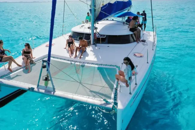 Relax, have a refreshing drink, and enjoy from the spectacular scenery of the blue sky and turquoise sea water while being onboard on a comfortable Private Catamaran half day 45 guests to Isla Mujeres