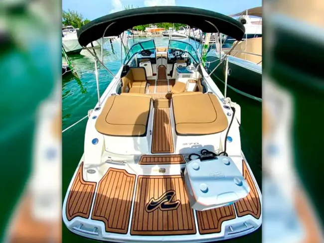 Elegant and exquisite small Private Yacht for Ten passengers: wooden floor, brown comfortable seats, shade, and a bathroom. perfect for a day out in your Cancun/Mexico vacation